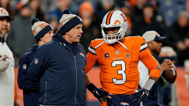 Denver Broncos head coach Sean Payton talks with quarterback Russell Wilson (3) before the game against the New England Patriots at Empower Field at Mile High.